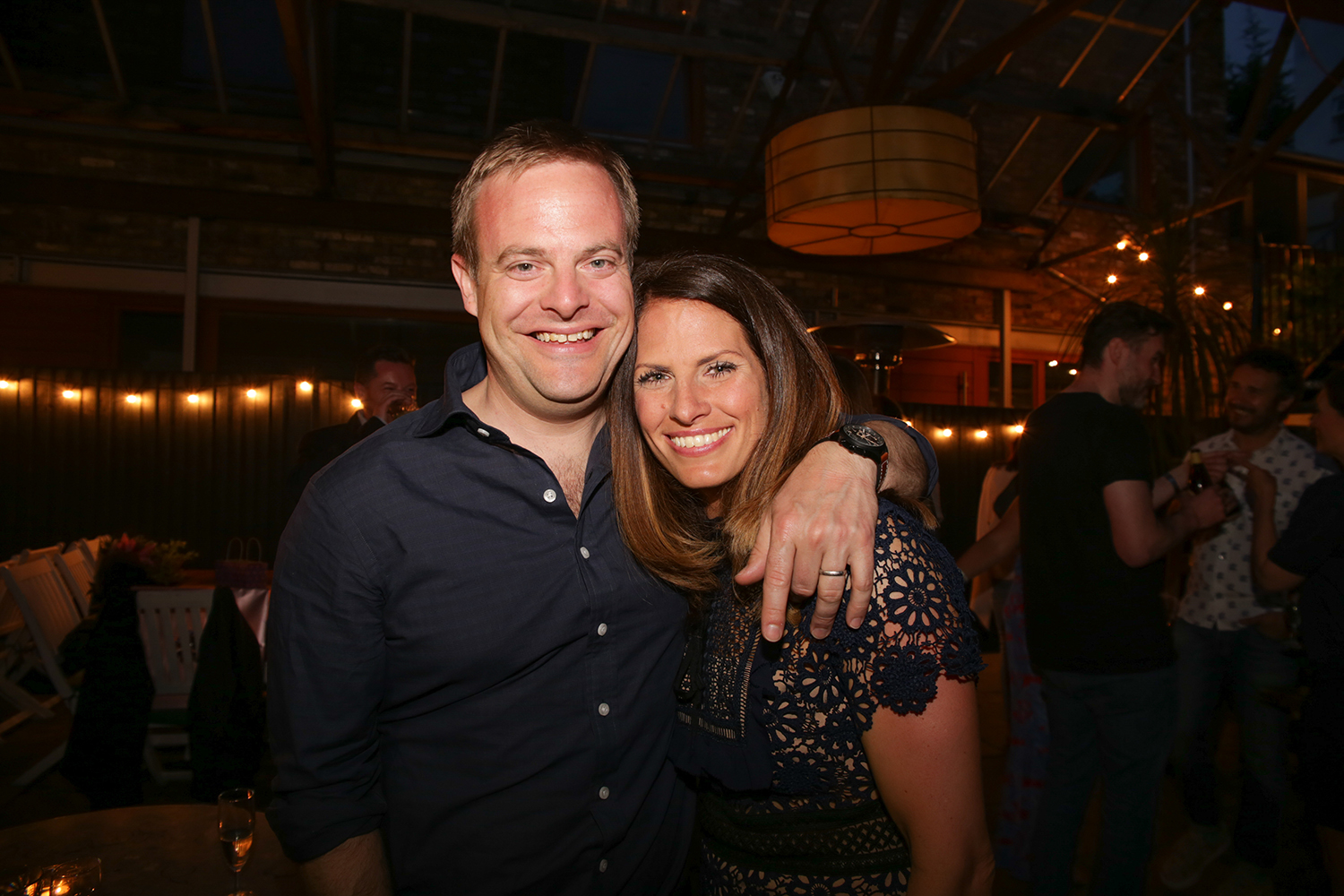 Man and woman smiling into camera at party