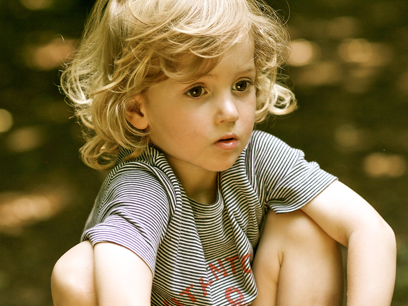 Little blonde boy sitting in the park in North London