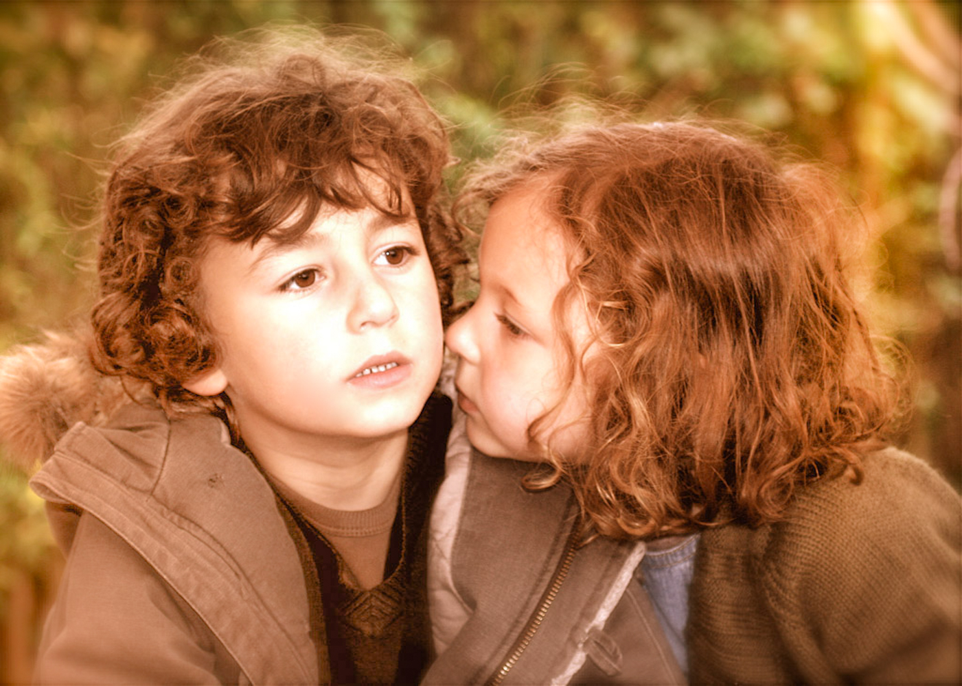 sister giving her brother a kiss on the cheek