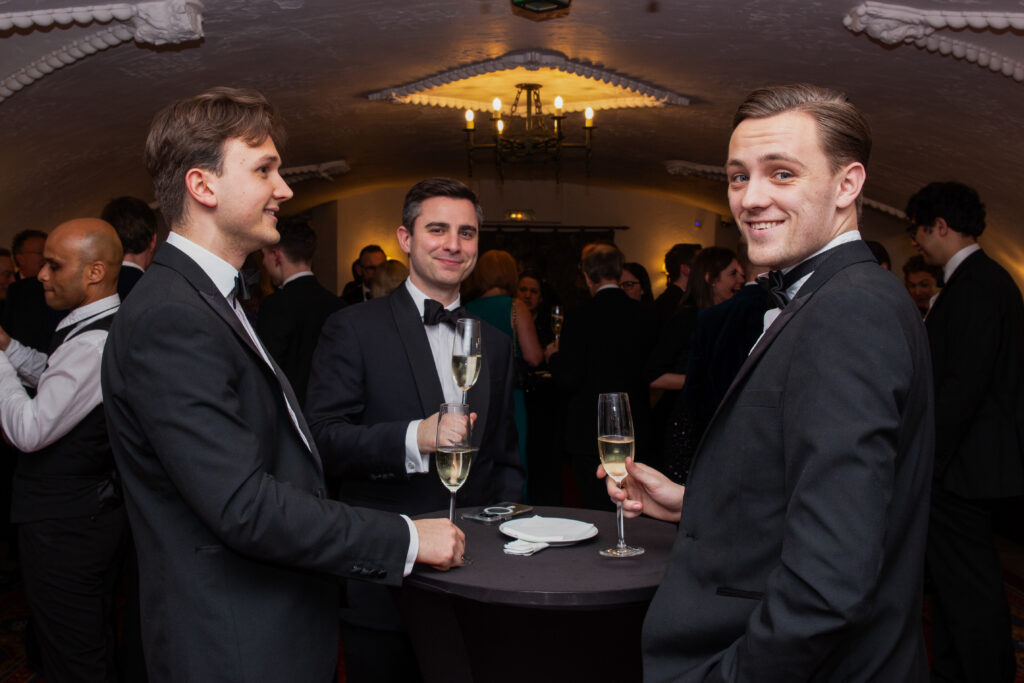 Three men in dinner jackets at corporate event