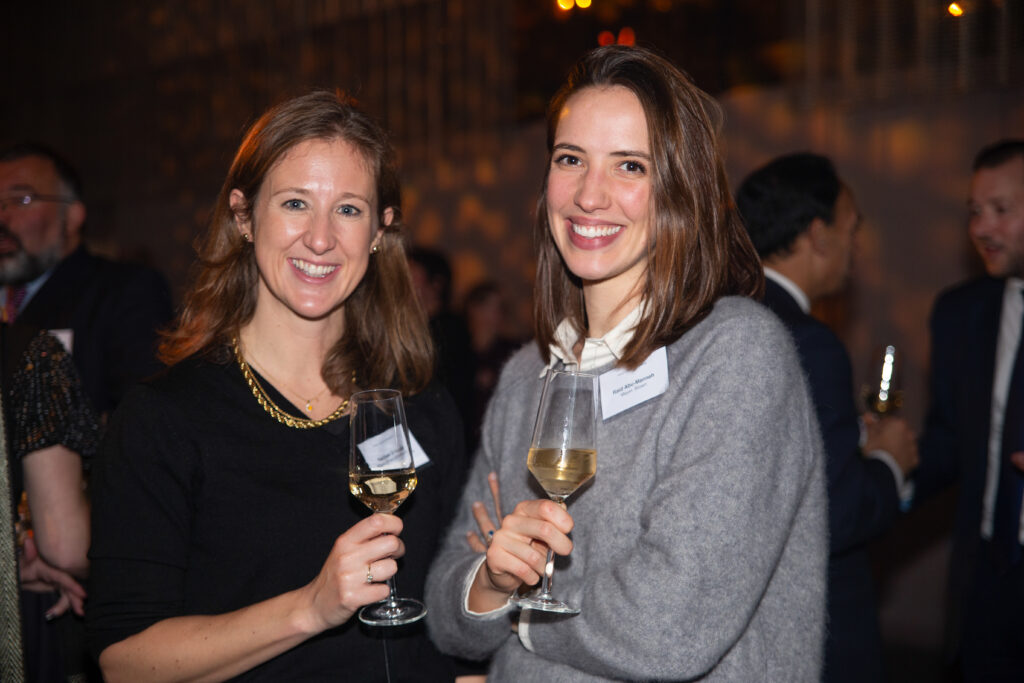 Two women with wine at corporate event